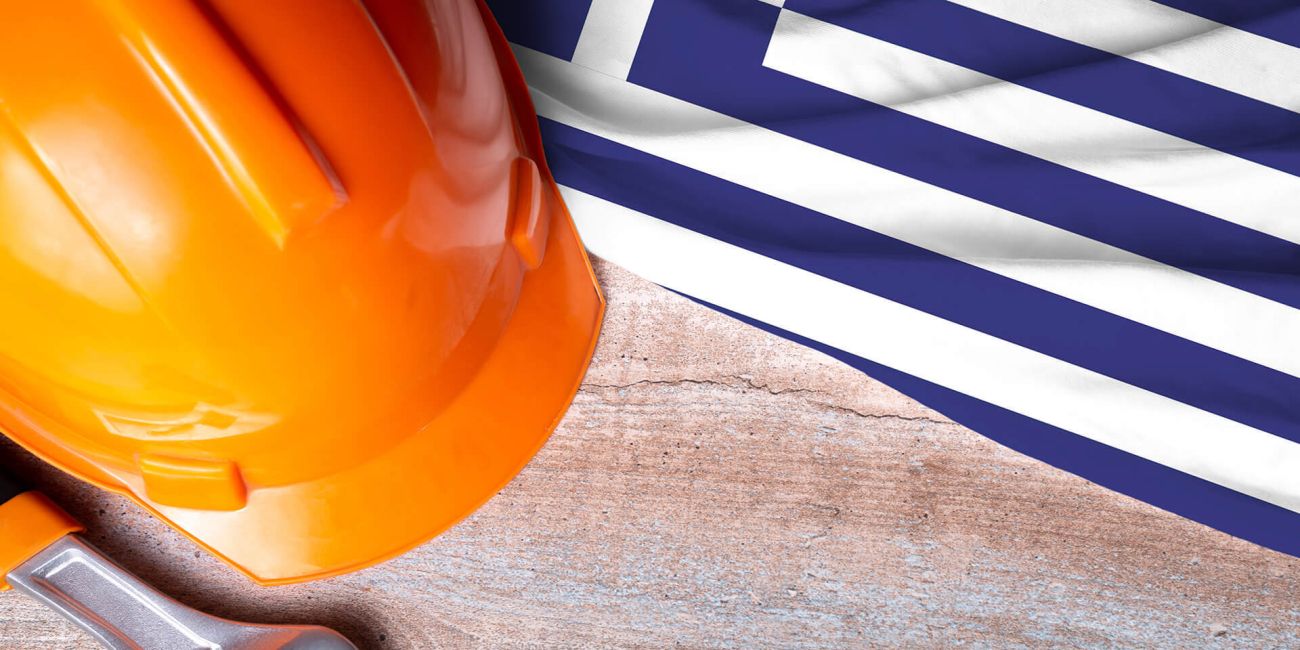 Greece flag and some construction tools on wooden background