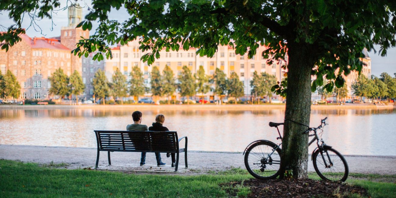 People sitting on the bench by the river