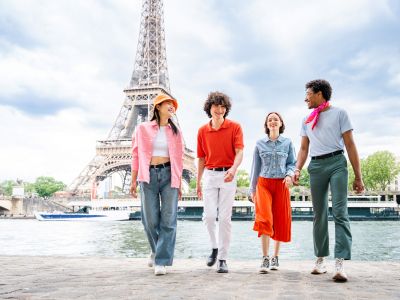 Group of young friends bonding outdoors and having fun sightseeing Paris and Eiffel Tower