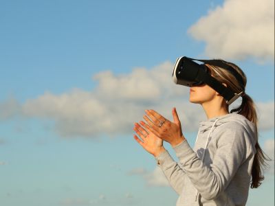 Woman using VR goggles outdoors